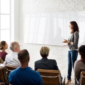 A woman keeping a lecture in front of audience